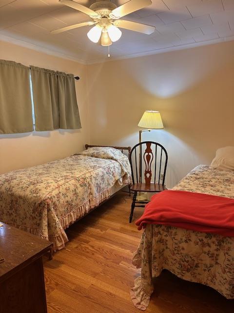 bedroom with wood finished floors and a ceiling fan