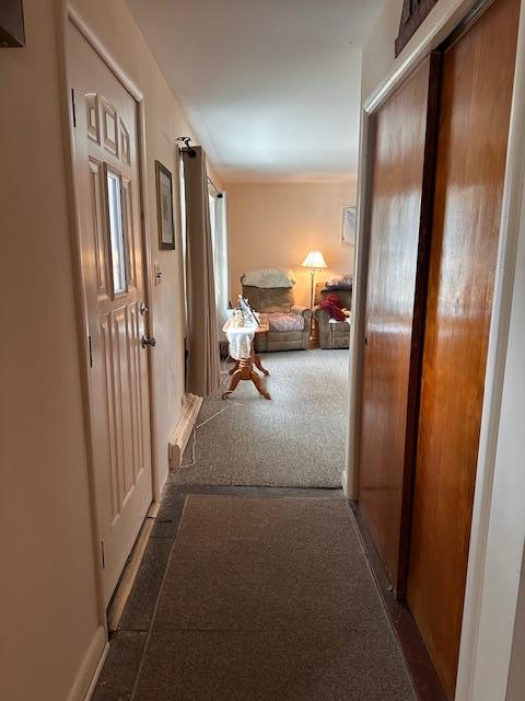 hallway with carpet flooring