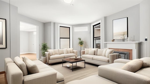 living room featuring baseboards, a fireplace, and wood finished floors