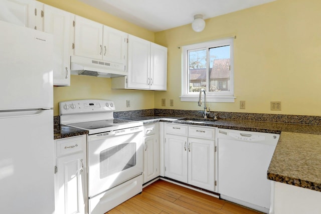 kitchen featuring white cabinets, under cabinet range hood, white appliances, and a sink