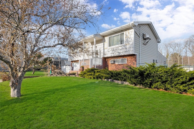 back of house featuring brick siding and a yard