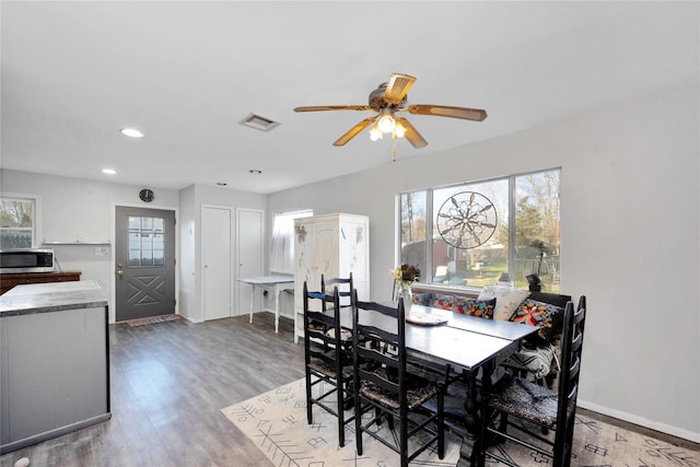 dining area with wood finished floors, ceiling fan, baseboards, visible vents, and recessed lighting