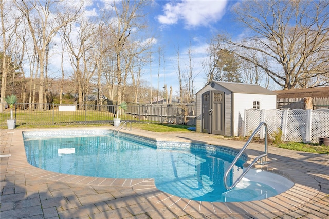 view of pool with a fenced in pool, fence, a shed, a patio area, and an outbuilding