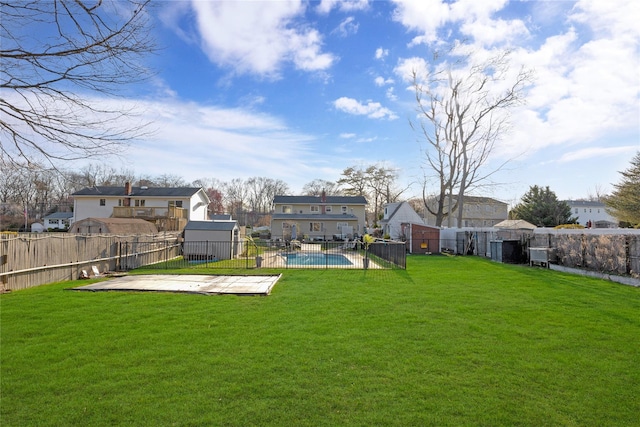 view of yard with a fenced backyard, a residential view, a patio, and a fenced in pool