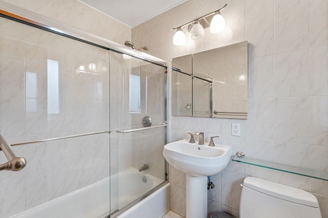 bathroom with toilet, shower / bath combination with glass door, tasteful backsplash, and tile walls