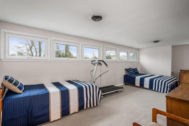 carpeted bedroom featuring visible vents