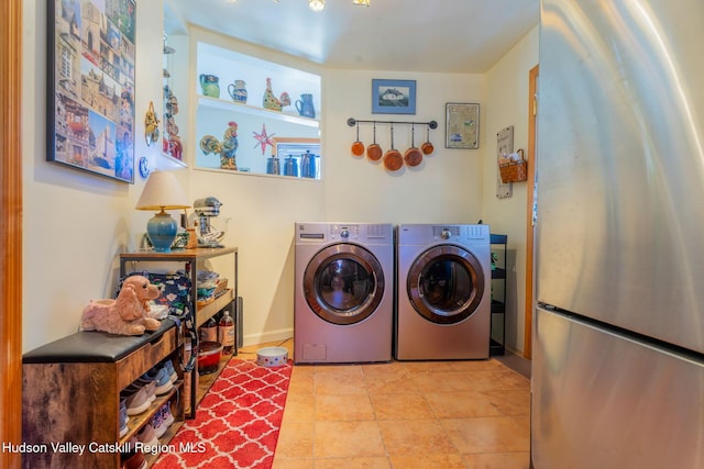 clothes washing area featuring washer and clothes dryer