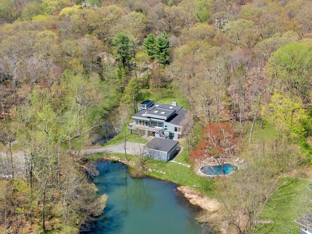 bird's eye view featuring a water view and a wooded view