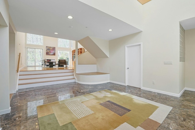 entryway with baseboards, recessed lighting, and marble finish floor