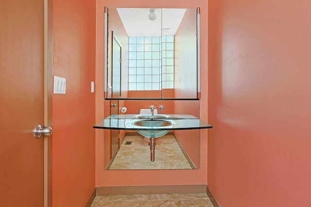 bathroom with baseboards and a sink