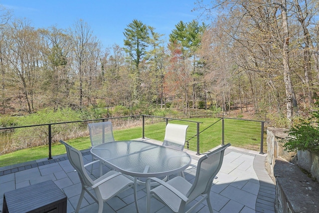 view of patio with outdoor dining area and fence