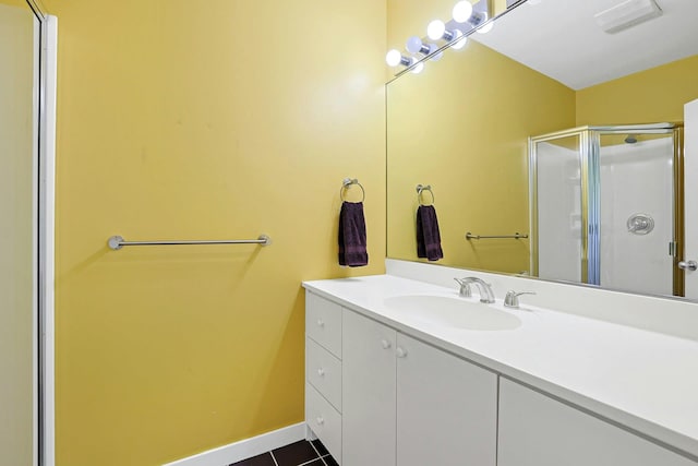 full bathroom featuring vanity, tile patterned flooring, visible vents, baseboards, and a stall shower