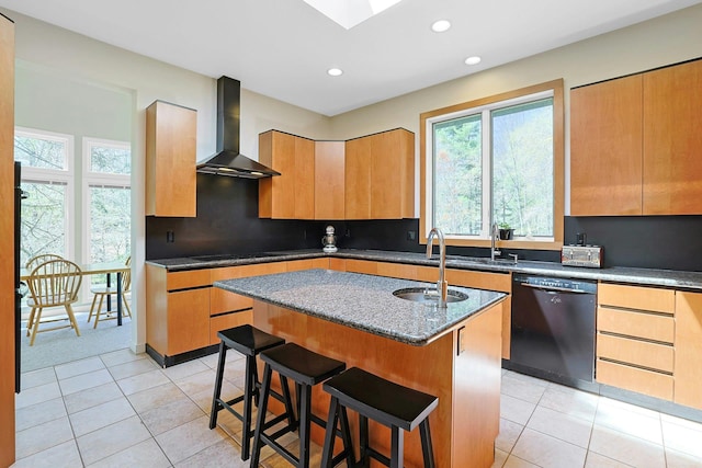 kitchen with a sink, light tile patterned floors, black appliances, and wall chimney exhaust hood