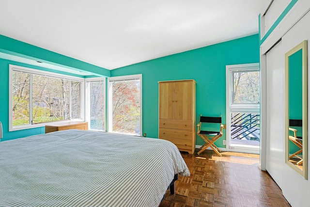 bedroom featuring an accent wall and vaulted ceiling
