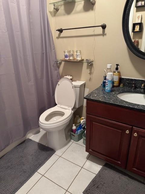 bathroom with toilet, tile patterned floors, a shower with shower curtain, and vanity