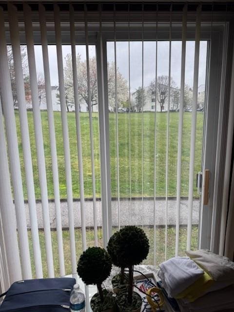sunroom featuring a water view