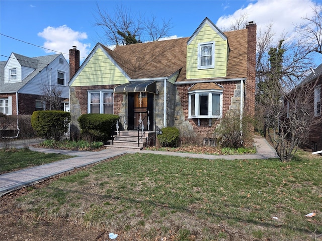 21741 112th Rd, Queens Village, NY 11429 - view of front of house with a chimney, a front yard, brick siding, and roof with shingles