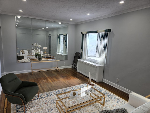 21741 112th Rd, Queens Village, NY 11429 - living area featuring a textured ceiling, crown molding, baseboards, wood finished floors, and radiator heating unit