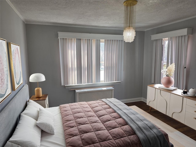 21741 112th Rd, Queens Village, NY 11429 - bedroom featuring crown molding, wood finished floors, a textured ceiling, radiator, and baseboards