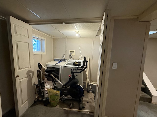 interior space with washing machine and dryer and a paneled ceiling