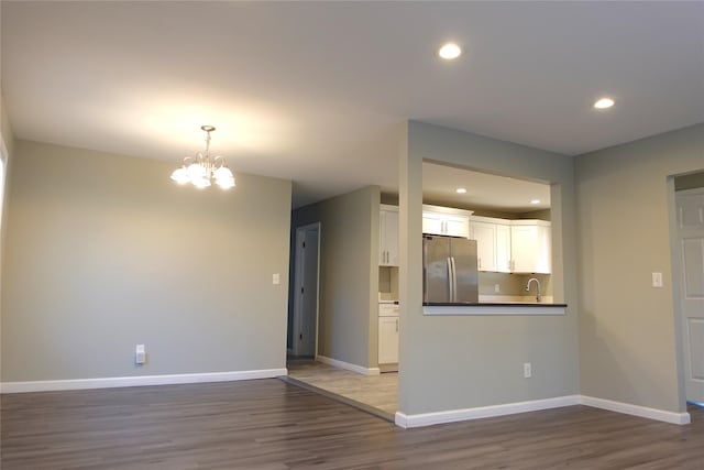 62 Eleanor Ave, Mastic, NY 11950 - unfurnished living room with dark wood-style flooring, a sink, and baseboards