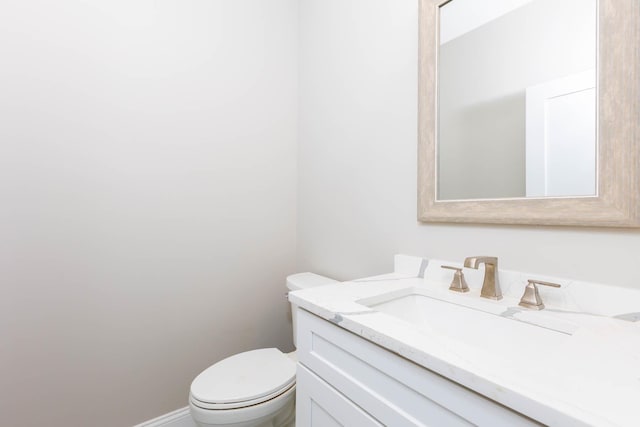 bathroom with toilet and vanity