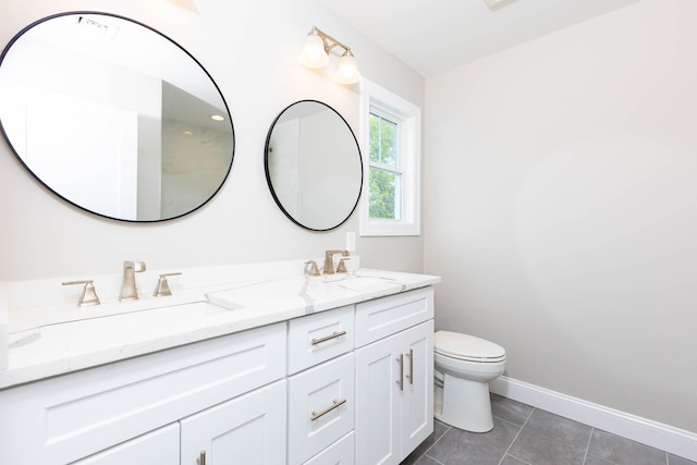 full bathroom with toilet, double vanity, tile patterned flooring, and baseboards