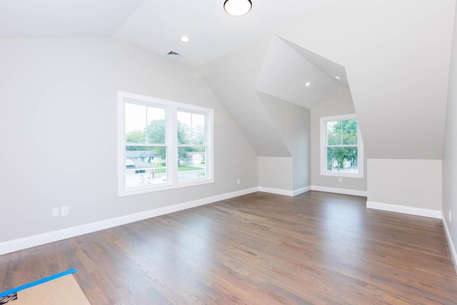 bonus room with lofted ceiling, baseboards, wood finished floors, and recessed lighting