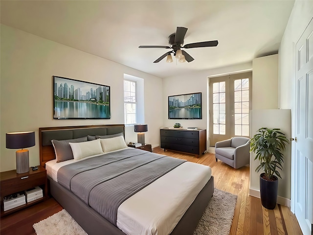 208 Centre Ave Unit 1A, New Rochelle, NY 10805 - bedroom with multiple windows, wood finished floors, and ceiling fan