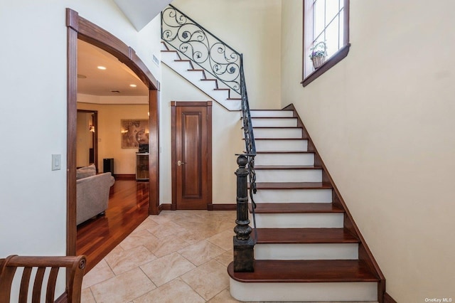 37-12 222nd St, Bayside, NY 11361 - stairs featuring arched walkways, baseboards, and tile patterned flooring