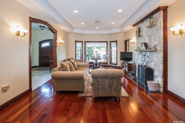 37-12 222nd St, Bayside, NY 11361 - living area with baseboards, arched walkways, wood finished floors, and a fireplace