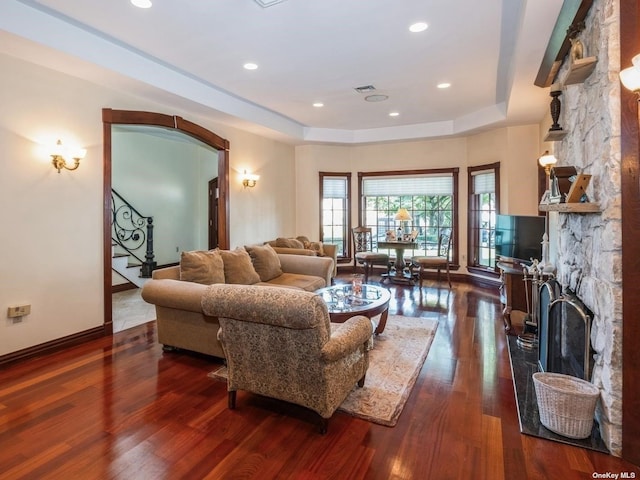 37-12 222nd St, Bayside, NY 11361 - living room featuring stairs, a raised ceiling, a fireplace, baseboards, and dark wood-type flooring