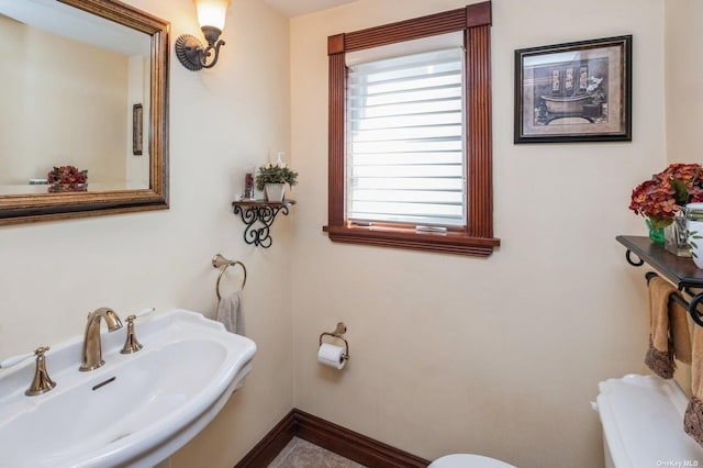 37-12 222nd St, Bayside, NY 11361 - half bathroom featuring toilet, a sink, and baseboards