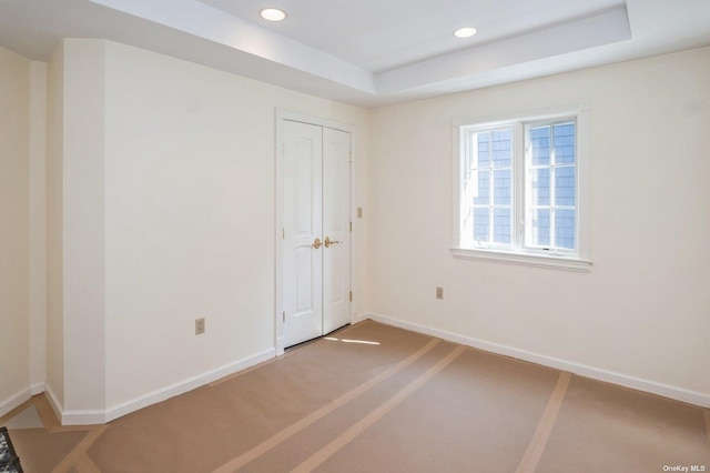 37-12 222nd St, Bayside, NY 11361 - unfurnished room with baseboards, a tray ceiling, and recessed lighting