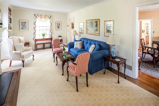 living room featuring baseboards, ornamental molding, and wood finished floors