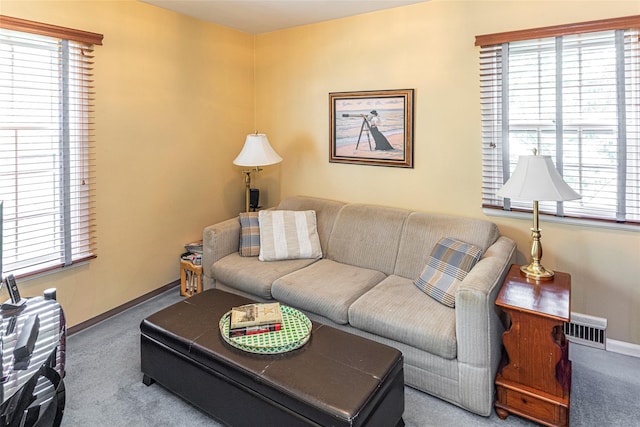 living area featuring carpet floors, baseboards, and visible vents