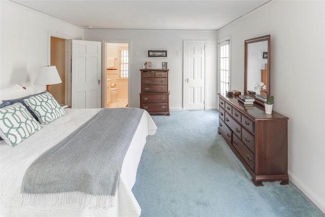 bedroom with baseboards, a closet, connected bathroom, and light colored carpet