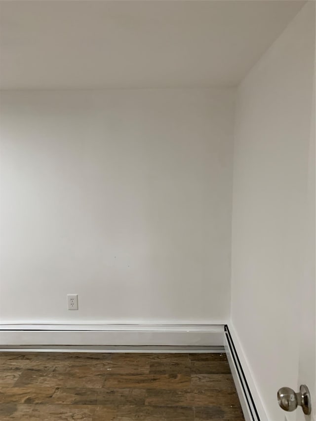 2263 Ryer Ave, Bronx, NY 10457 - empty room featuring baseboards, wood finished floors, a baseboard heating unit, and baseboard heating