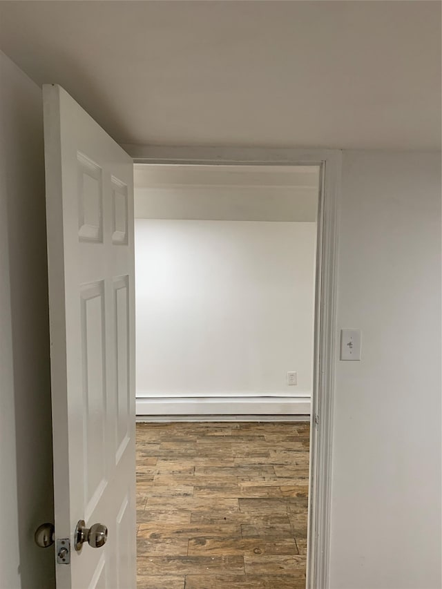 2263 Ryer Ave, Bronx, NY 10457 - hall with a baseboard radiator and wood finished floors