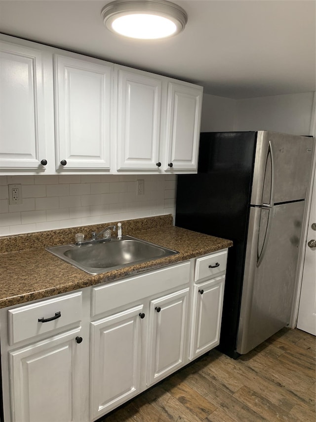 2263 Ryer Ave, Bronx, NY 10457 - kitchen featuring dark countertops, tasteful backsplash, white cabinetry, a sink, and dark wood-style floors