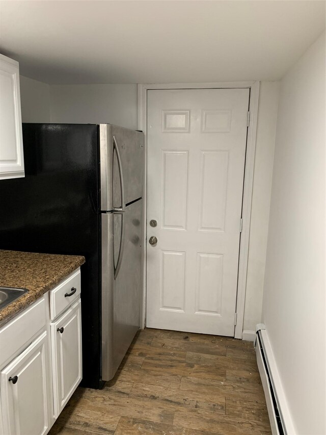 2263 Ryer Ave, Bronx, NY 10457 - kitchen with dark countertops, dark wood-style floors, freestanding refrigerator, white cabinets, and baseboard heating
