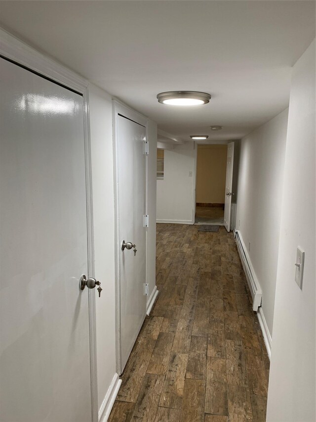 2263 Ryer Ave, Bronx, NY 10457 - hallway featuring dark wood-style floors, baseboards, and a baseboard heating unit