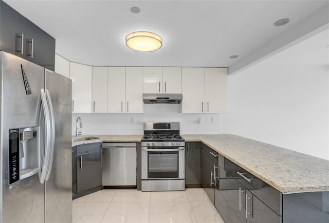 45-16 83rd Rd Unit E6J, Elmhurst, NY 11373 - kitchen featuring light stone countertops, a peninsula, appliances with stainless steel finishes, marble finish floor, and under cabinet range hood