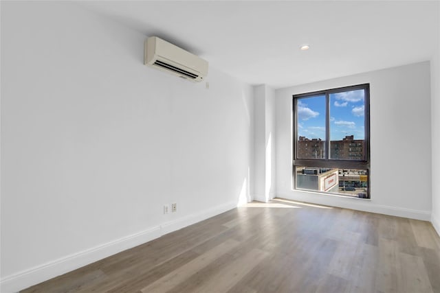 45-16 83rd Rd Unit E6J, Elmhurst, NY 11373 - spare room featuring wood finished floors, baseboards, an AC wall unit, and recessed lighting