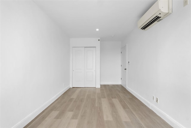45-16 83rd Rd Unit E6J, Elmhurst, NY 11373 - interior space featuring a closet, baseboards, an AC wall unit, light wood-style floors, and recessed lighting