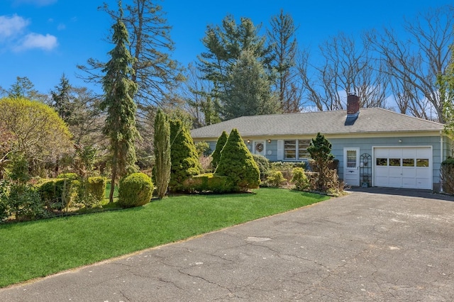 495 Knollwood Ln, Mattituck, NY 11952 - view of front facade with an attached garage, a chimney, driveway, and a front yard