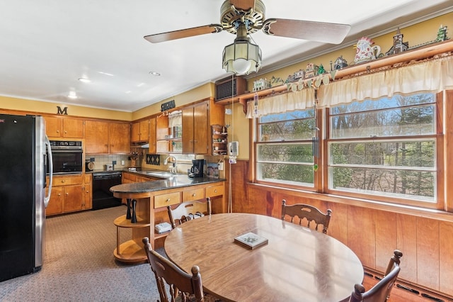 495 Knollwood Ln, Mattituck, NY 11952 - dining area featuring wooden walls, a ceiling fan, and wainscoting