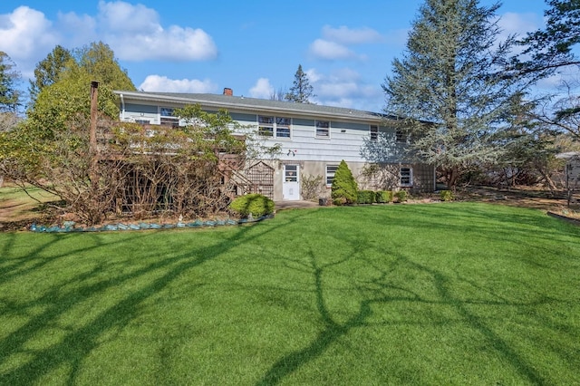 495 Knollwood Ln, Mattituck, NY 11952 - back of property featuring a yard and a chimney