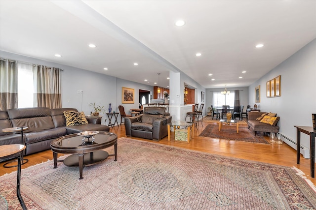 580 Foxhurst Rd, Baldwin, NY 11510 - living room featuring wood finished floors, a chandelier, baseboard heating, and recessed lighting