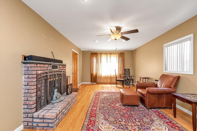 580 Foxhurst Rd, Baldwin, NY 11510 - living area with a fireplace, ceiling fan, light wood finished floors, and baseboards